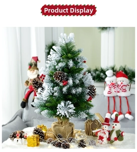 Close-up of a 60cm snow-flocked mini Christmas tree with pine cones and burlap base