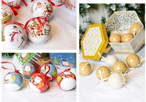 Close-up of colorful painted foam Christmas balls with Santa and snowman patterns in a gift box