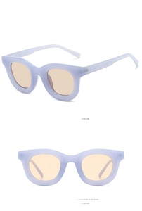 Detail view of retro purple matte frame sunglasses with brown round lenses from two angles