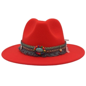 Detail of red fedora hat featuring bohemian turquoise band and decorative gray tassels