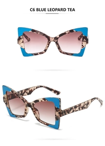 Detail view of blue leopard pattern cat eye sunglasses with brown gradient lenses
