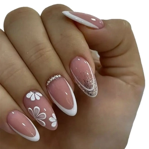 Long almond French press-on nails with white tips, 3D flower accents and sparkling rhinestones