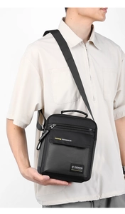 Men's black nylon crossbody bag with fashion print and adjustable strap on model