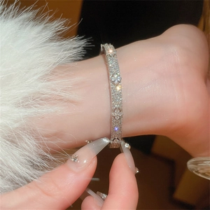 Close-up of sparkling zircon flower bracelet with star motifs on a model's wrist