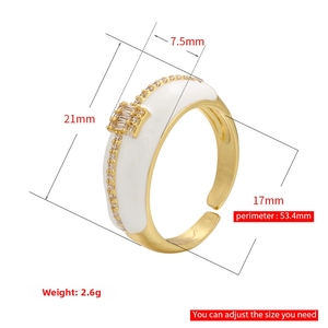 Detailed view of adjustable gold-plated ring with size specs and white enamel inlay