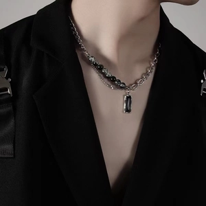 Industrial style titanium steel necklace with zircon pendant and mixed beads on a model