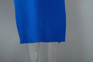 Detail of royal blue ribbed knit texture and side slit hem on a bodycon dress