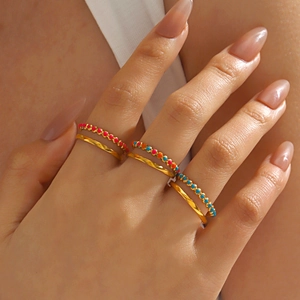 Set of 6 gold adjustable rings for women with colorful enamel beads on model's hand
