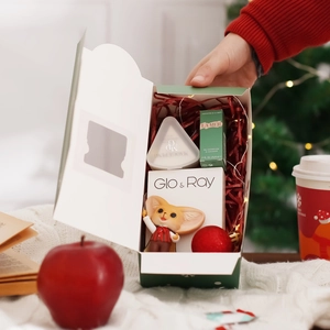 Christmas luxury cosmetics gift set with skincare and plush fox in festive holiday setting