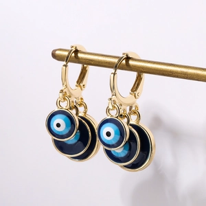 Golden hoop earrings featuring three cascading evil eye charms in blue and white enamel