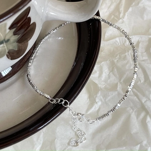 Close-up of S925 silver irregular crushed beads bracelet with heart charm and extension chain