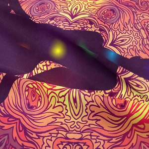 Macro shot of bohemian mandala tapestry fabric showing high-density fiber texture and colors