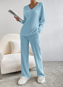 Detail of light blue V-neck knitted loungewear set with soft ribbed texture and wide-leg pants