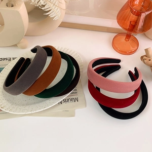 Elegant wide velvet padded headband set in vintage colors with soft glossy texture