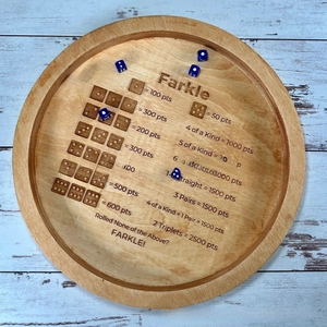Detail of wooden Farkle dice tray showing engraved scoring rules and blue dice
