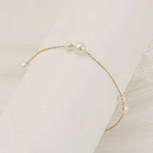 Minimalist stainless steel bracelet with white pearls and 18K gold chain links