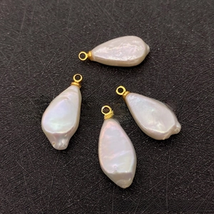 Detailed view of four irregular baroque freshwater pearl pendants with gold hoops