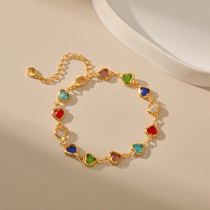 Detail of adjustable gold-plated chain bracelet with multi-color heart gemstones