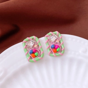 Macro shot of vintage style square earrings with colorful beads and zircon stones