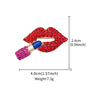 Detail showing dimensions of red rhinestone lip and lipstick brooch with measure lines