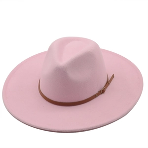 Side top view of pink wide brim fedora hat with brown leather decorative band