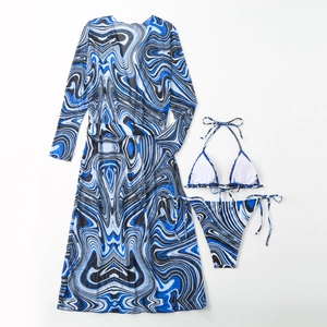 Detailed flat lay of three-piece bikini set with blue marble print and mesh beach cover-up