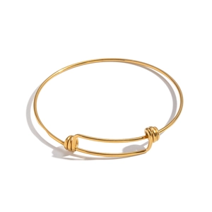 Polished 18K gold plated stainless steel adjustable bangle on a minimalist white background