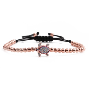 Adjustable rose gold turtle bracelet with pink and blue crystals on black woven cord