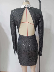 Detailed back view of sequin dress featuring large triangle cutout and pearl collar