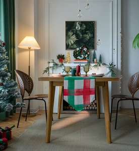 Close-up of a festive red and green plaid table runner with a rustic texture