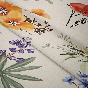 Close-up of woven fabric texture showing vibrant botanical floral patterns on beige background