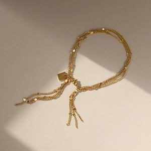 Elegant 18k gold plated triple layer chain bracelet with disc charms and tassel fringe