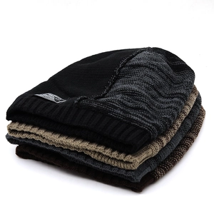 Folded winter knit beanies in black, khaki, and grey featuring ribbed cuffs and thick texture