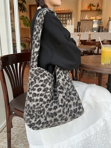 Faux shearling leopard print tote bag with large capacity worn by model in a cafe