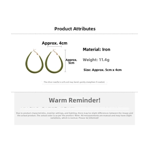 Detailed view of dark green drop earrings with silver pins and iron metal structure