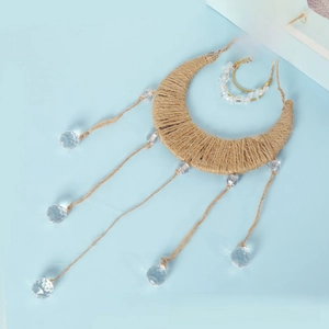 Macro shot of hemp rope woven moon decor with dangling faceted crystal prism balls