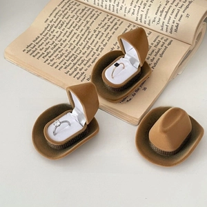 Brown cowboy hat jewelry box with velvet texture and soft white lining for rings
