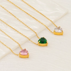 Three heart-shaped zircon necklaces in pink, green, and white on gold chains