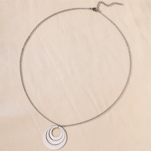 Detailed view of the triple interlocking stainless steel ring pendant on a link chain