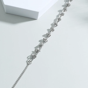 Silver twisted link chain bracelet with industrial interlocking design and adjustable chain