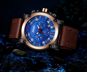 Detail of blue sunray dial chronograph with rose gold bezel and red stitching leather strap