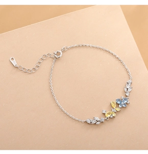 Detailed macro view of S925 sterling silver bracelet with multi-color butterfly gemstones