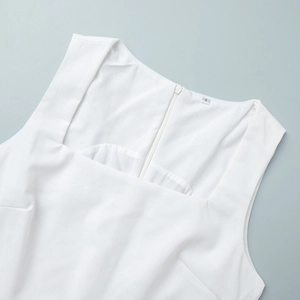 Detail of square neckline and back zipper on a white sleeveless cotton linen dress