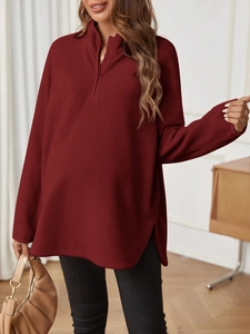 Detail of burgundy fleece maternity top with quarter-zip neckline and soft fabric texture
