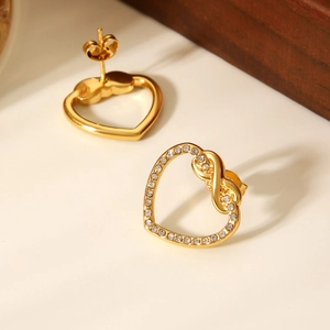 Detail of gold heart earrings showing front crystal inlay and back with butterfly clasp