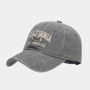 Detailed close-up of retro washed grey baseball cap with high-quality embroidery