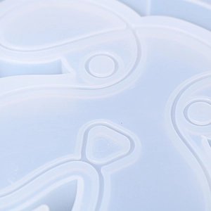 Macro detail of a light blue silicone dog plate mold with cartoon animal features