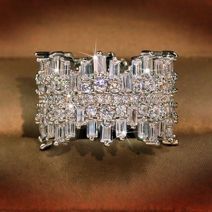 Luxury irregular wide band ring featuring baguette and round cubic zirconia pavé setting