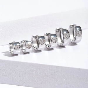 Three pairs of silver heart-shaped huggie hoop earrings with micro zircon pave in graduated sizes