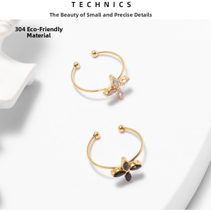Detail of 18k gold plated stainless steel rings with purple and black clover petals